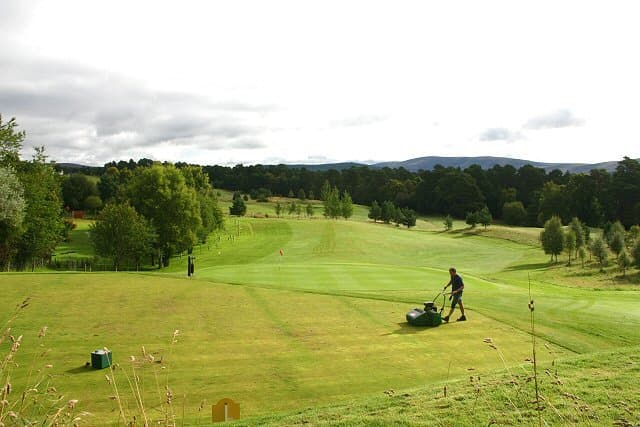 A fairway being mown at Grantown-on-Spey, with the Cromdale Hills beyond