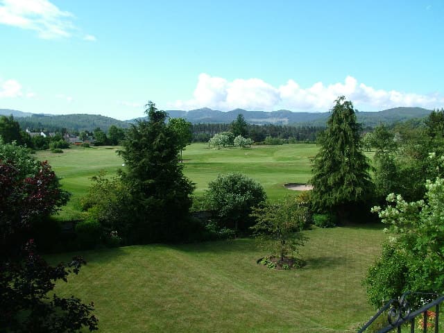 Ballater Golf Course from the village, with the hills of Deeside behind