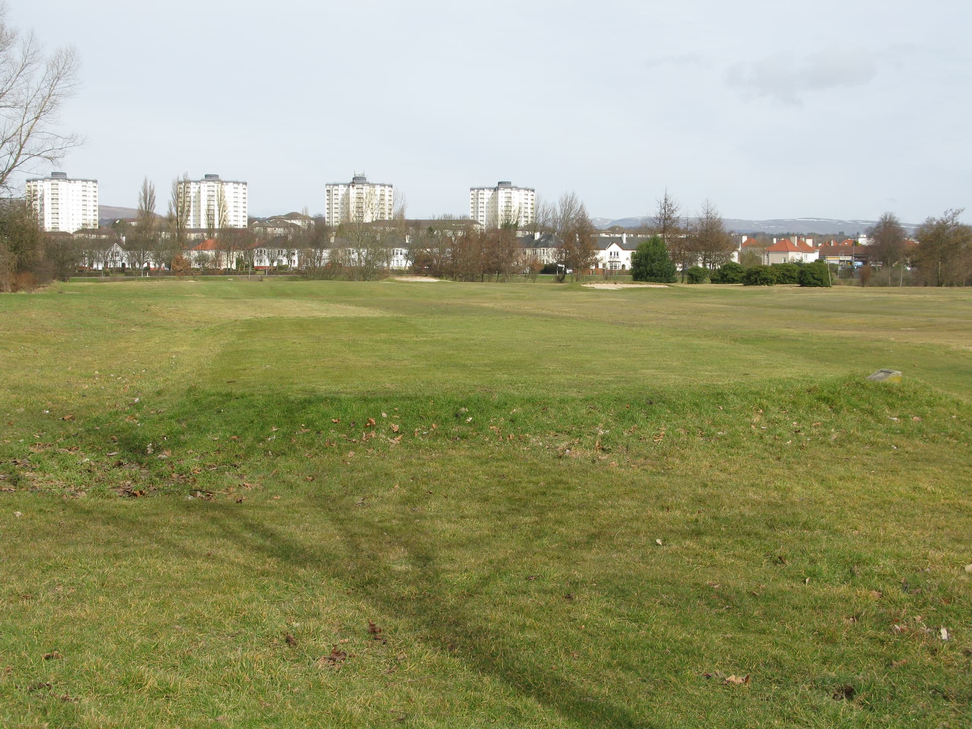 The nine-hole municipal course at Knightswood, Glasgow, tower blocks on the skyline