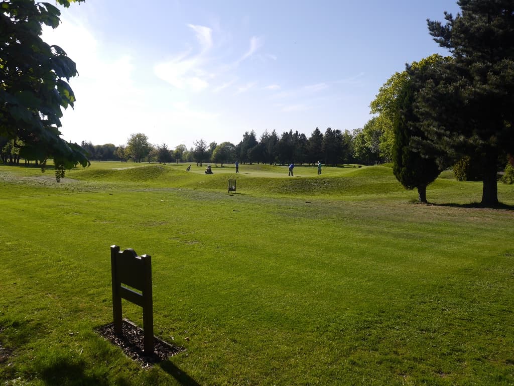 Parkland fairways at Royal Musselburgh, Prestongrange, golfers on the practice ground