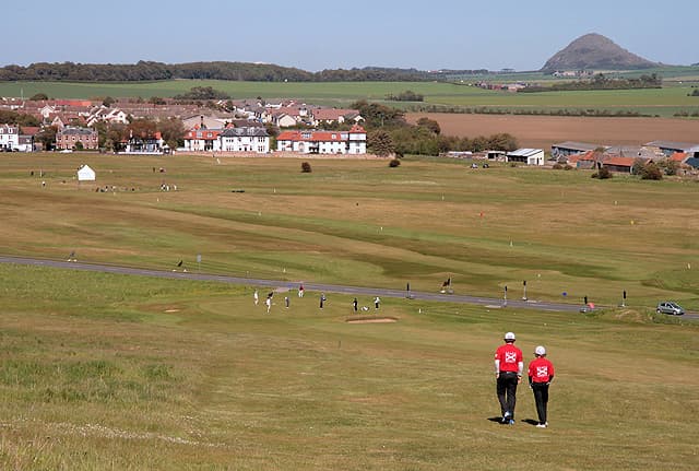 Golfers walking the No. 2 course above Gullane, with North Berwick Law beyond