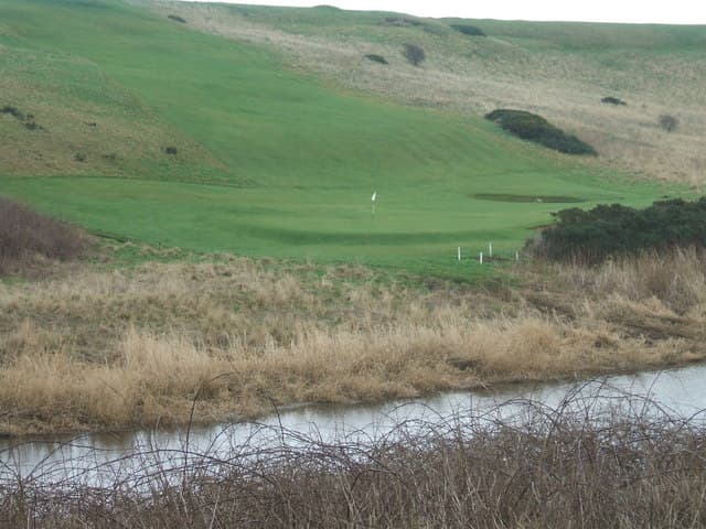 A green below the dunes at Peterhead, seen from across the Ugie